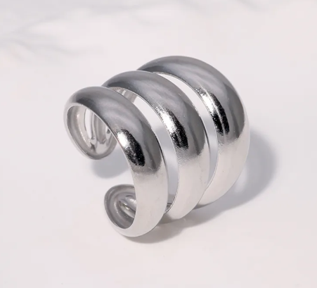 Anillo grueso triple, ajustable. Color plateado.