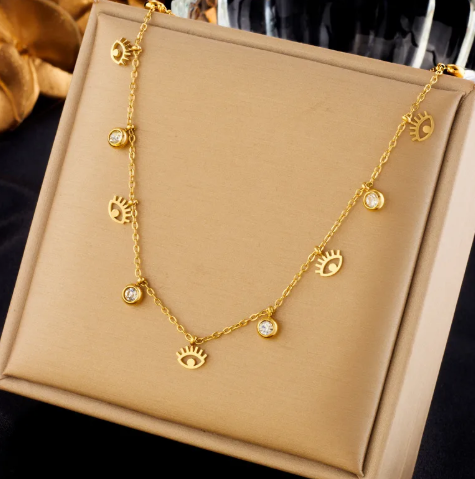 Collar con minidijes de ojos y circonias. Color dorado.